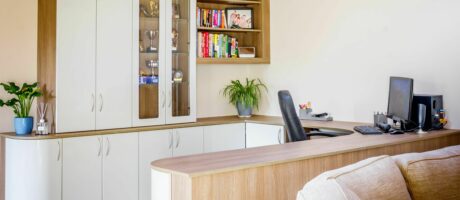 Large home office with bespoke home office furniture including shelves, cupboard storage and desk